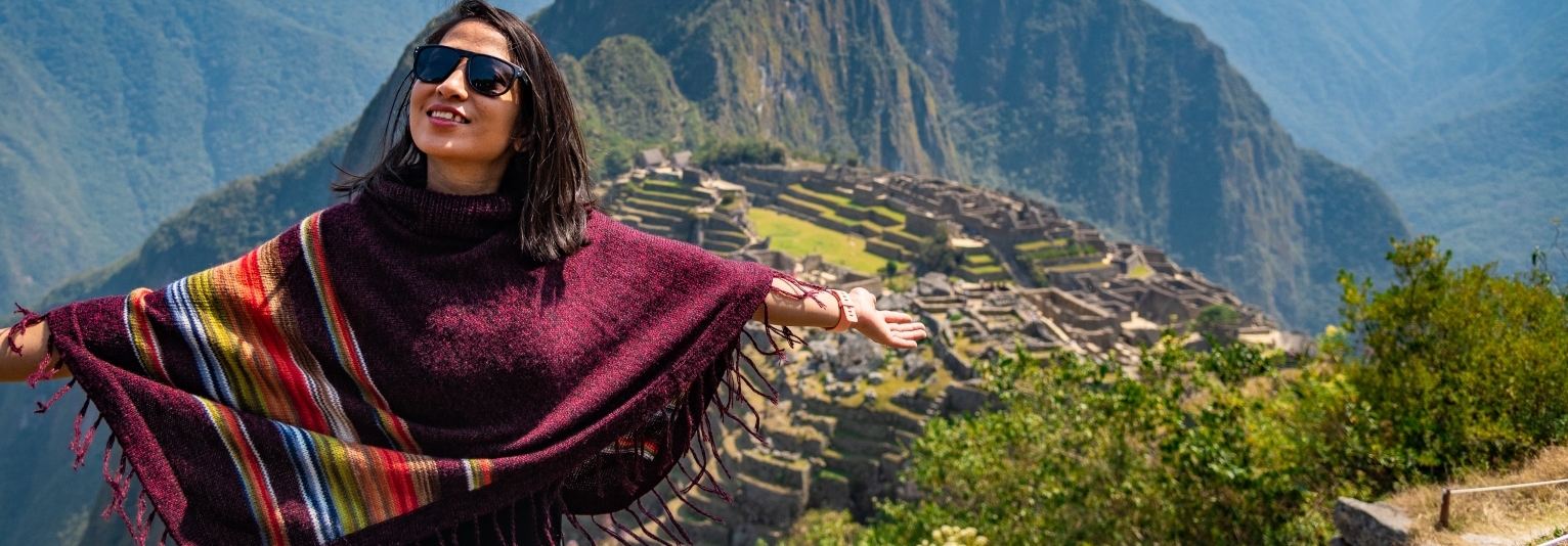 Woman enjoying the view of Machu Picchu Peru South America